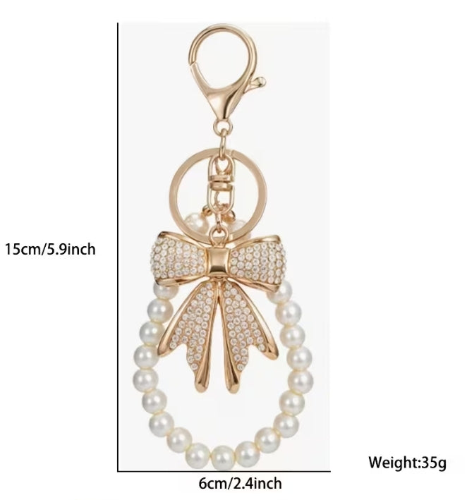 Enchanting faux pearl and rhinestone bow keychain.