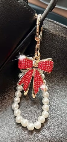 Enchanting faux pearl and rhinestone bow keychain.