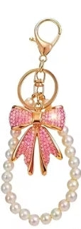 Enchanting faux pearl and rhinestone bow keychain.